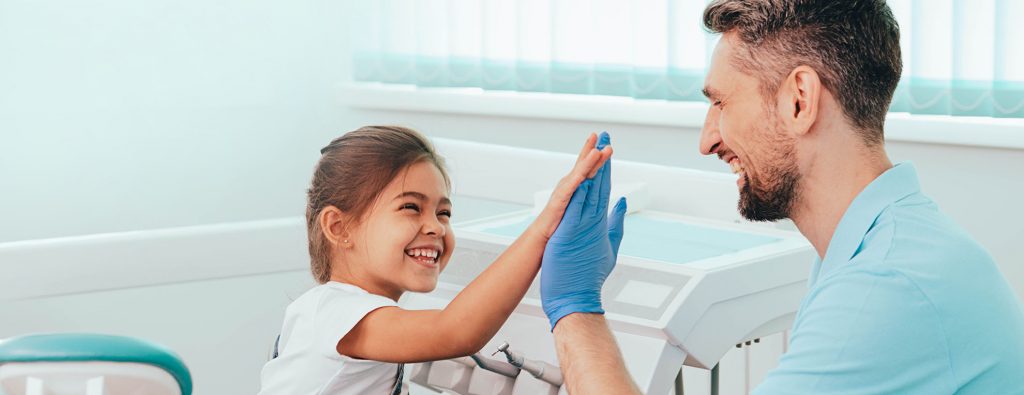 Pediatric dentist with child patient