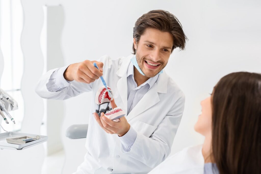 A dental professional showing proper brushing techniques